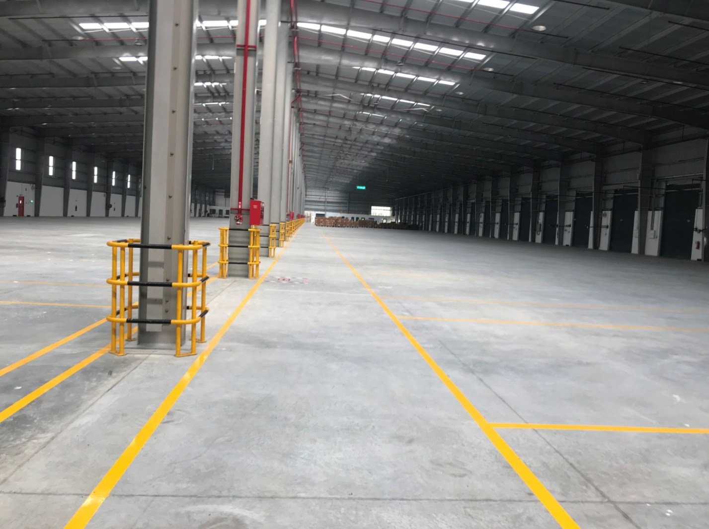 Warehouse construction Chennai - large warehouse interior with yellow floor markings