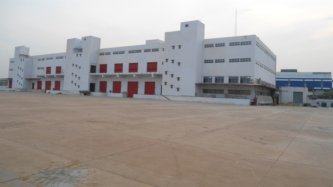 Turnkey factory construction India - white industrial building with red accents
